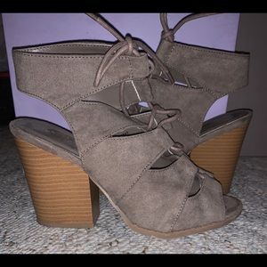 Taupe colored heeled shoe.